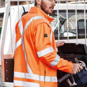 A bright orange unisex hi-vis softshell jacket with reflective stripes, displayed on a male model.