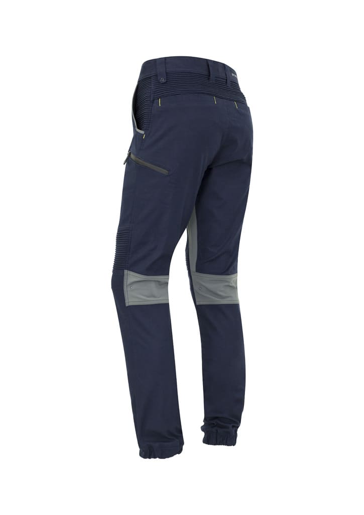 Navy work pants with cuffed hems, featuring a grey panel and a zip pocket, designed for comfort and flexibility.