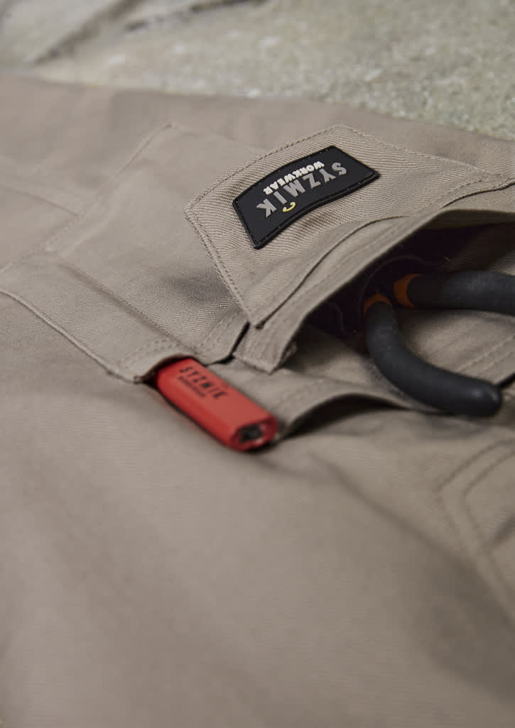 Rugged cooling stretch cargo pants in beige with a logo patch and tool loops.