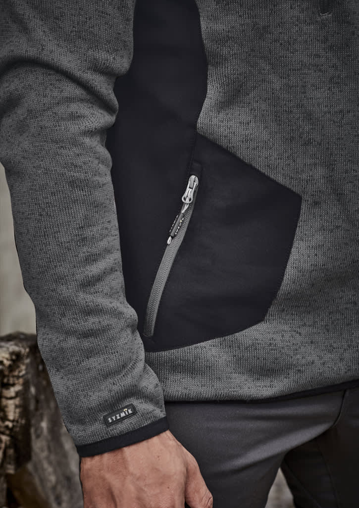 A grey and black unisex pullover featuring a zippered pocket and a logo on the sleeve.