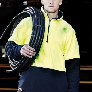 A unisex hi-vis yellow and navy polar fleece pullover with a half zip and a logo, held by a person with a cable.