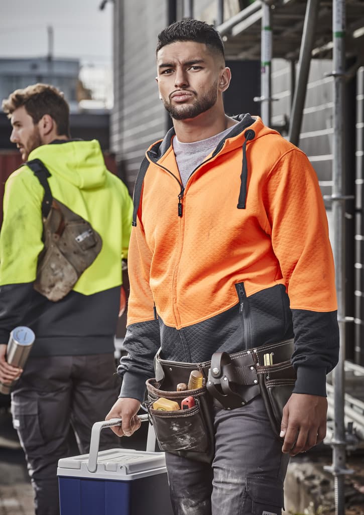 A vibrant orange and black unisex hoodie with a textured jacquard design, featuring a logo and pockets.