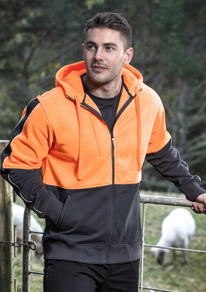 A unisex hi-vis full zip hoodie in bright orange and black, featuring a logo, worn by a model outdoors.