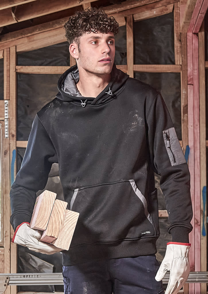 An orange water-resistant hoodie with a logo and a diagonal black detail, paired with black pants and gloved hands.
