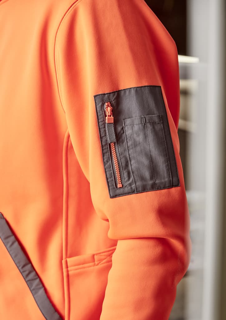 An orange unisex water-resistant hoodie featuring a front pocket and a logo, worn by a person working on a surfboard.