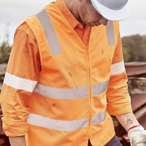 An orange unisex hi-vis vest with silver reflective strips, worn over a long-sleeve shirt, featuring a safety helmet.