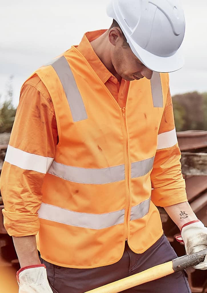 An orange unisex hi-vis vest with silver reflective strips, worn over a long-sleeve shirt, featuring a safety helmet.