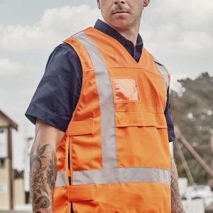 A unisex hi-vis safety vest in bright orange, featuring reflective strips and pockets, shown on a model.