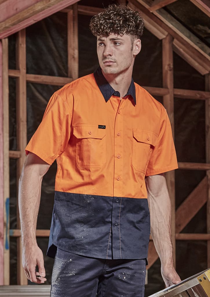 A short sleeve work shirt in bright orange and navy blue, featuring two chest pockets and a logo.