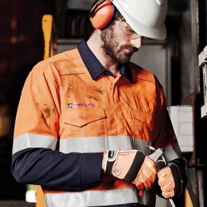 A man in a hi-vis orange and navy shirt with hoop taping, wearing safety earmuffs and a helmet.