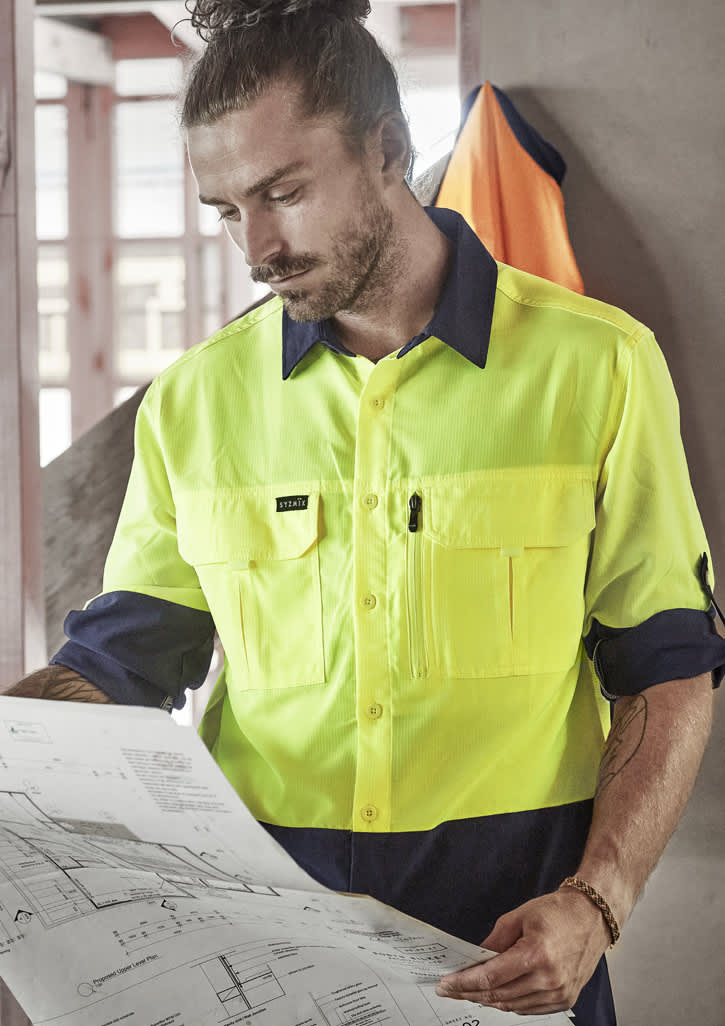 A high-visibility long sleeve shirt in fluorescent yellow and navy, featuring multiple pockets and a logo.