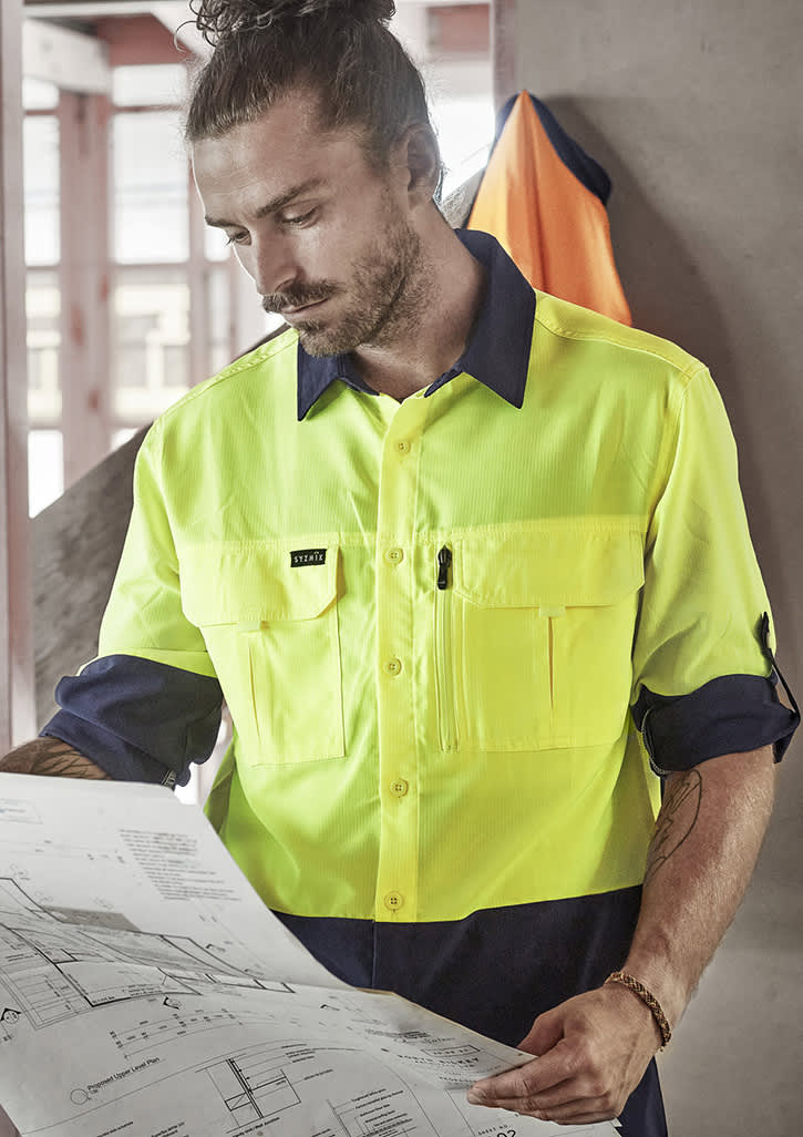 A men's hi-vis long sleeve shirt in bright yellow and navy, featuring a logo and pockets.