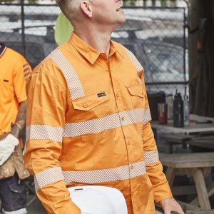 An orange long-sleeve work shirt with segmented reflective tape, featuring a pocket and a branding logo.