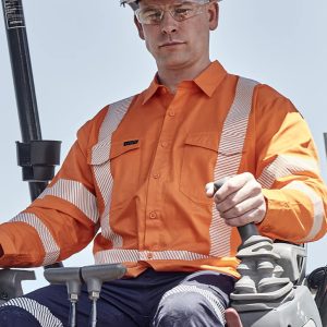 A man wearing an orange hi-vis shirt with segmented reflective tape operates machinery while wearing a white hard hat and safety glasses.