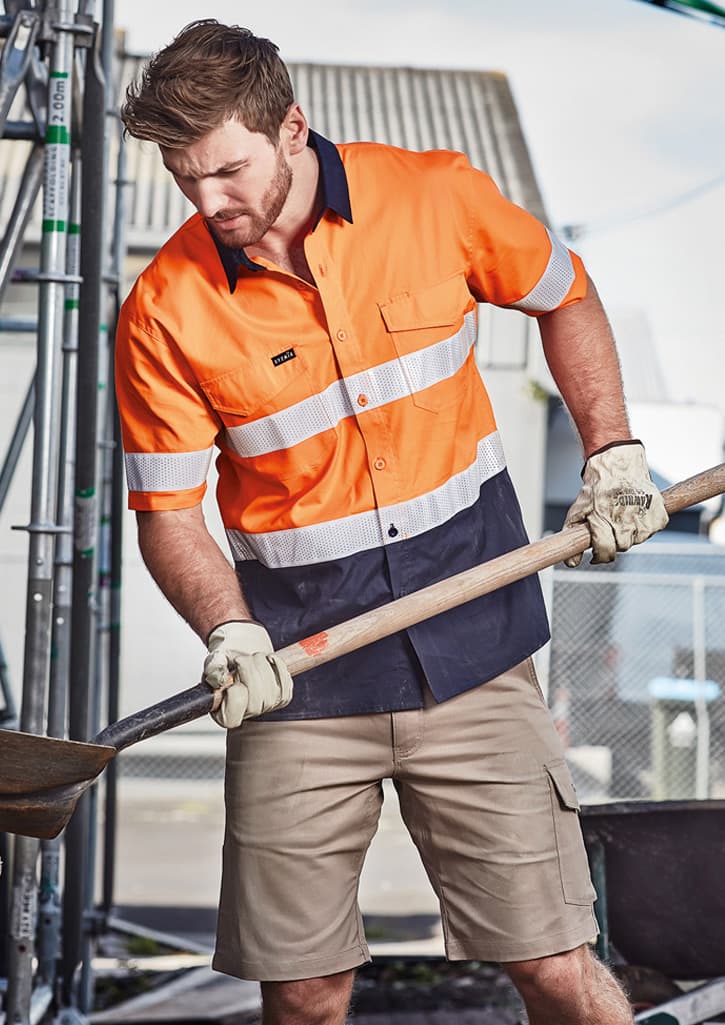 A short sleeve shirt in orange and navy with reflective tape, designed for workwear purposes. It features a branded logo.