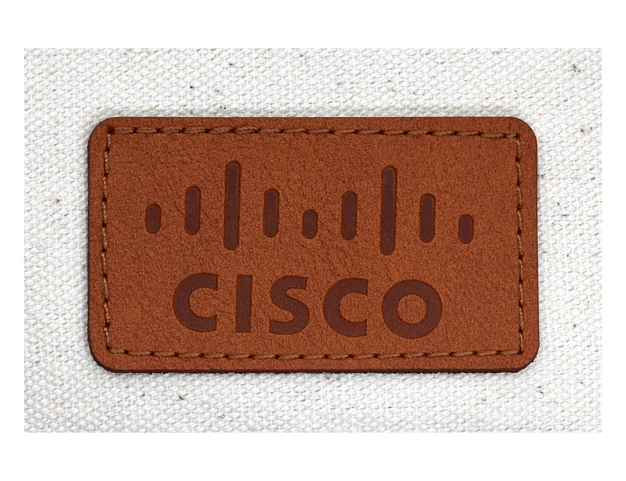 A tan leather patch with a brown embossed design and the word 