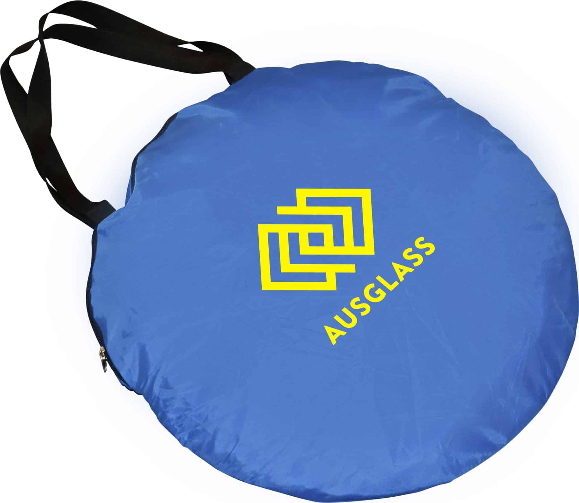 A blue pop-up beach shelter with a black strap and a logo on the surface.