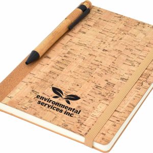 A cork-covered A5 notebook with an elastic band and a pen, featuring a logo on the front.