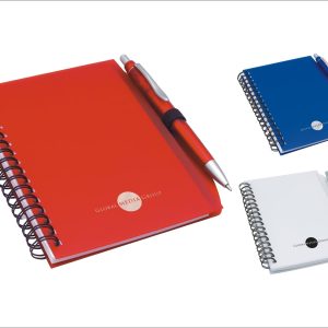 A red notepad with a pen, spiral-bound, alongside blue and white variants, featuring a logo.