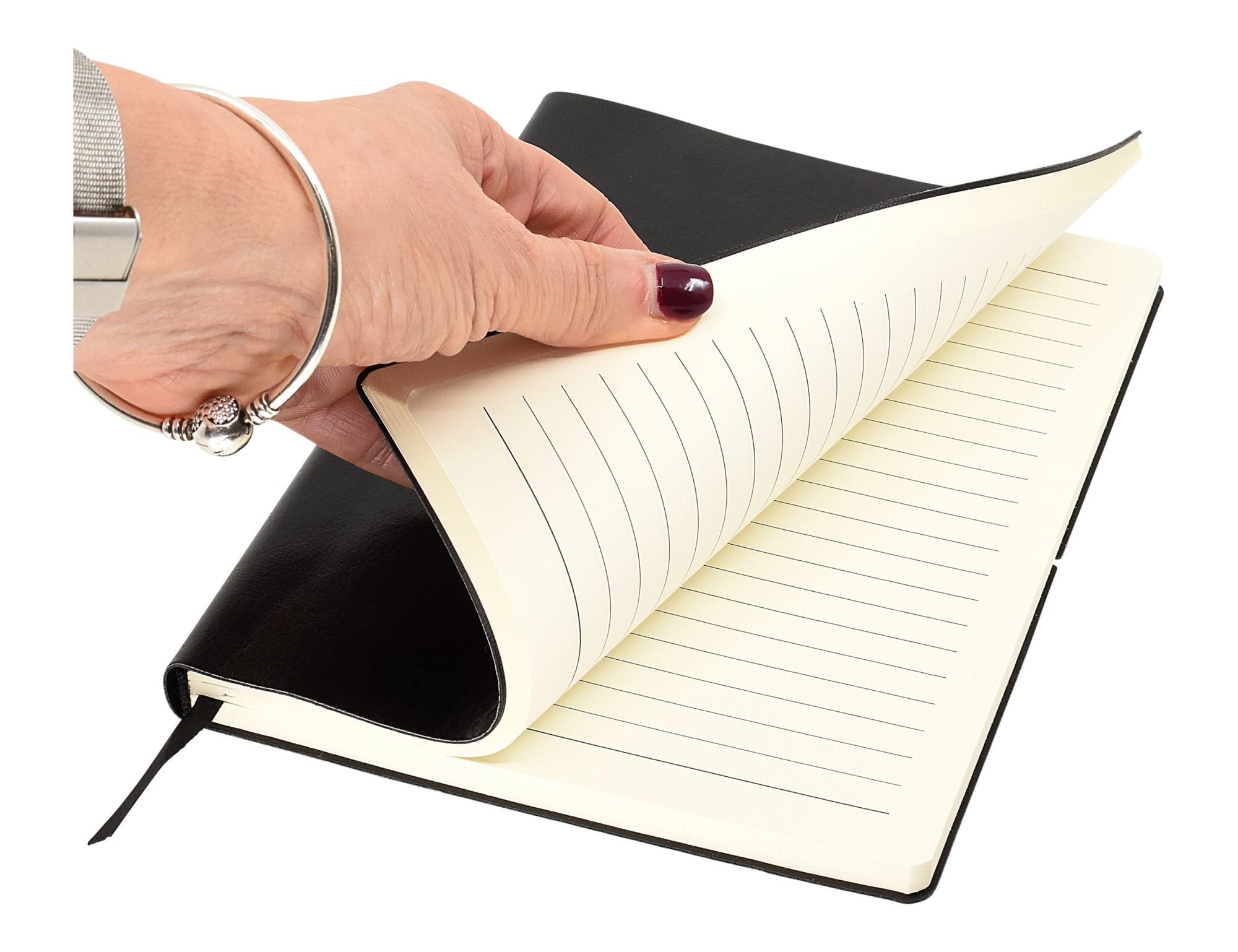 A black A5 notepad with lined pages, partially opened, held in a hand.