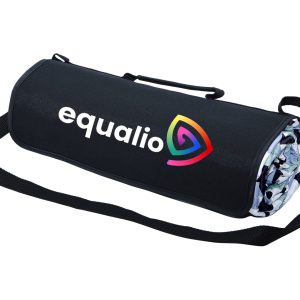 An extra-large picnic rug in a rolled, compact form, featuring a black outer layer and a colourful interior design.