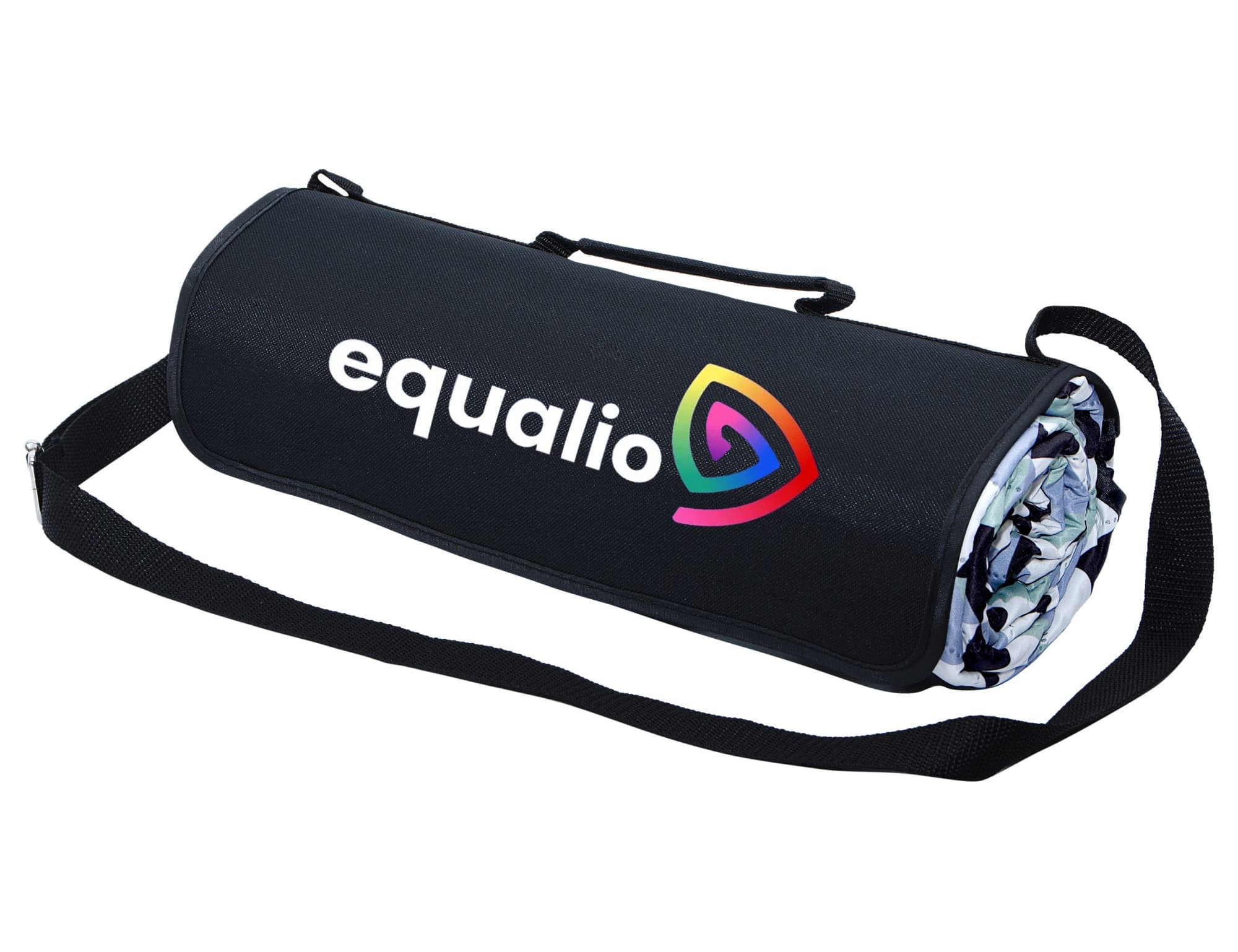 An extra-large picnic rug in a rolled, compact form, featuring a black outer layer and a colourful interior design.
