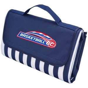 A navy picnic rug with a striped design and a branding logo, featuring a carry handle for easy transport.