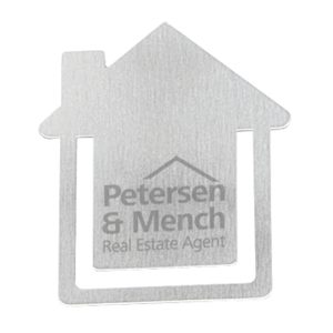 A metallic business card holder shaped like a house with a logo and branding on the surface.