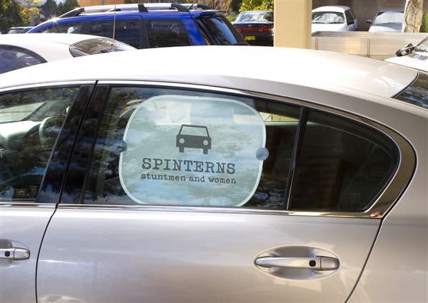 A car window featuring a round sunshade with a graphic of a car and the text 