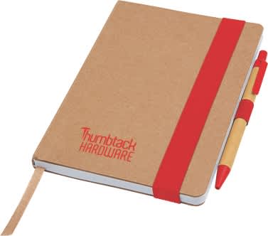 A brown notepad with a red elastic band and a matching pen resting beside it. It features a logo on the cover.