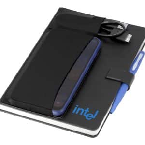 A black notebook with a pen, a phone sleeve, and a charging cable, featuring a logo on the cover.