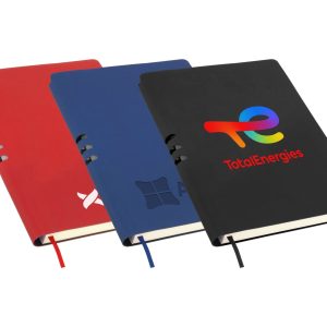 A set of three A5 notebooks in red, blue, and black, each featuring a logo on the cover and a ribbon bookmark.