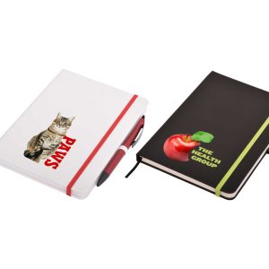 A white notepad with a cat graphic and a black notepad with an apple graphic, both featuring elastic bands.