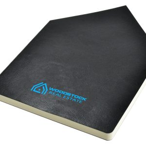A black A5 notebook with a textured cover and a logo on the front.