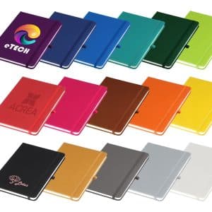 A collection of A5 notebooks in various colours, each with a decorative logo, displayed in a row.