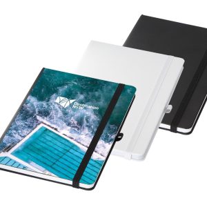 A set of three A5 notebooks in black, white, and a design featuring a blue swimming pool, with an elastic band closure.