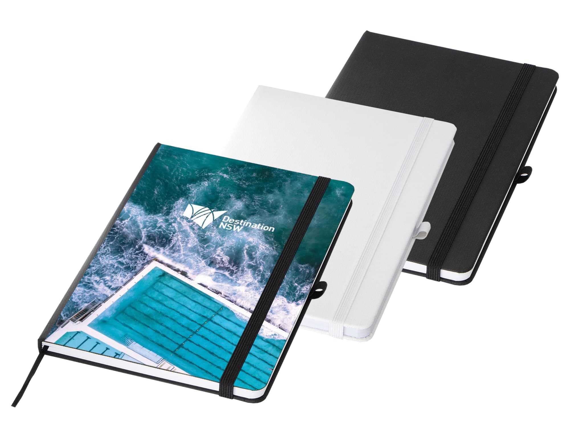 A set of three A5 notebooks in black, white, and a design featuring a blue swimming pool, with an elastic band closure.