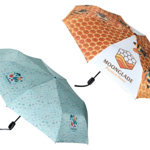 A full-colour umbrella featuring a honeycomb design and a pattern with small colourful icons. It has a logo on one panel.