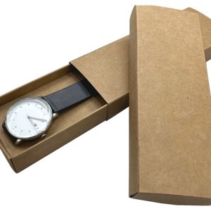 A brown paper watch box, partially opened, revealing a silver watch with a white face and black strap inside.