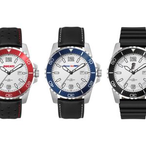 Sports watches with silver cases and white dials, featuring red, blue, and black silicone or leather straps. Each has a logo.