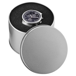 A round silver watch case containing a dark watch, set against a textured black background.