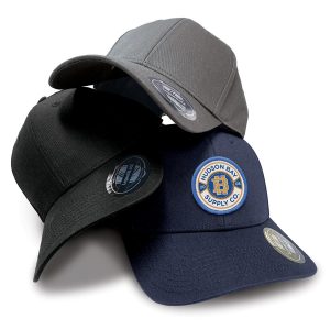 Three caps in grey, black, and navy, featuring a logo on the front, stacked together on a white background.