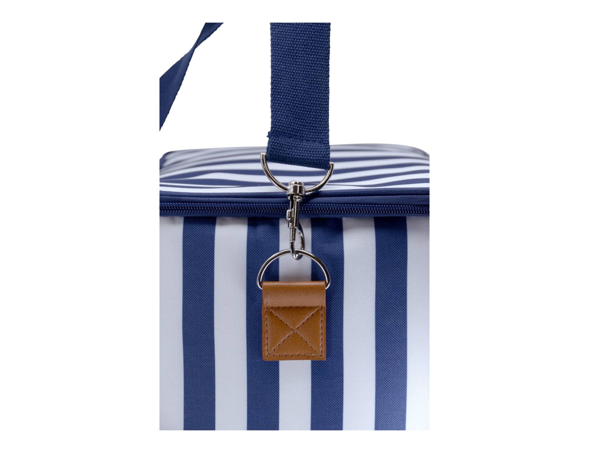 A cooler bag featuring navy and white stripes with a sturdy handle and a brown leather tag.