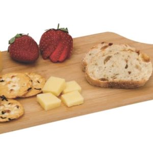 A wooden cheese board with slices of cheese, crackers, bread, and strawberries, featuring a logo on the handle.