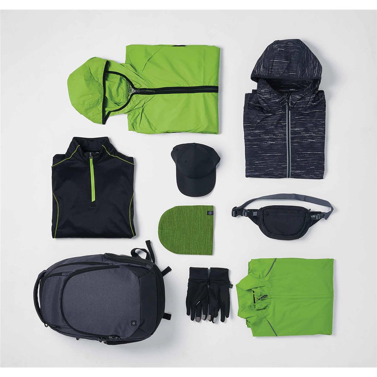 A grey backpack, black and green clothing items, a cap, a beanie, gloves, and a waist pack arranged neatly.