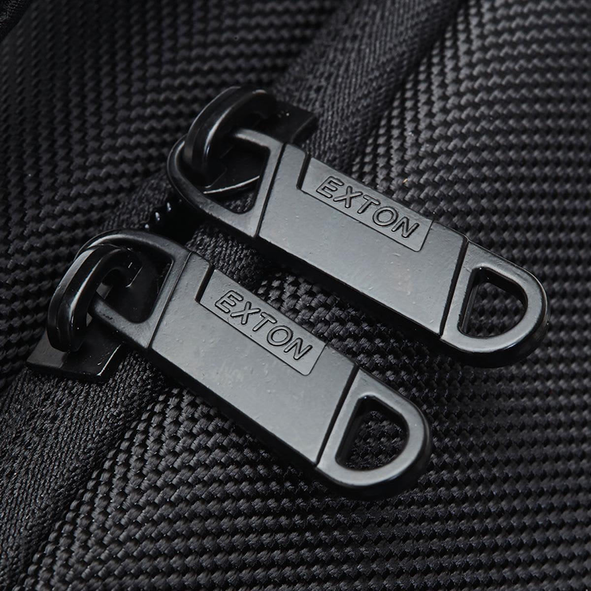 Close-up of black zippers with a branding logo on a textured fabric, part of the Exton Laptop Backpack.