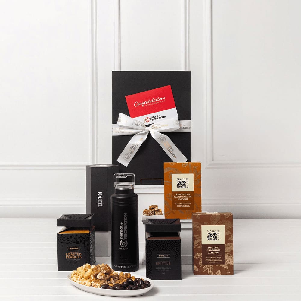 A black gift pack featuring a drink bottle, gourmet snacks, and assorted chocolates, presented with a decorative ribbon and card.