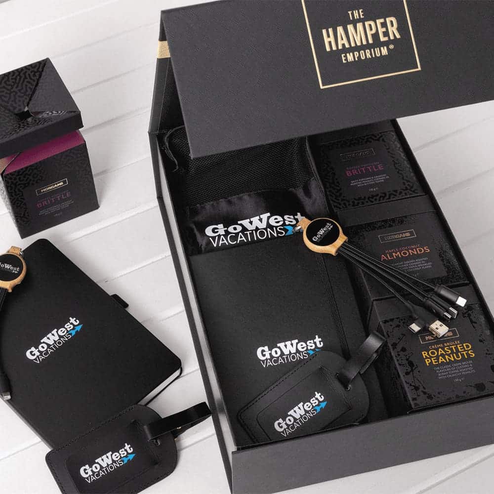 A custom travel kit featuring a black bag, snack packs, luggage tags, and a logo.