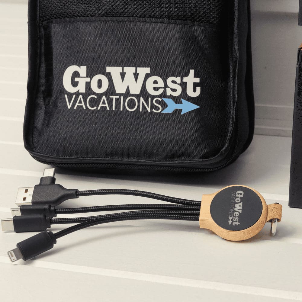 A black travel kit with a logo, featuring a multi-cable charger with USB and other connectors.