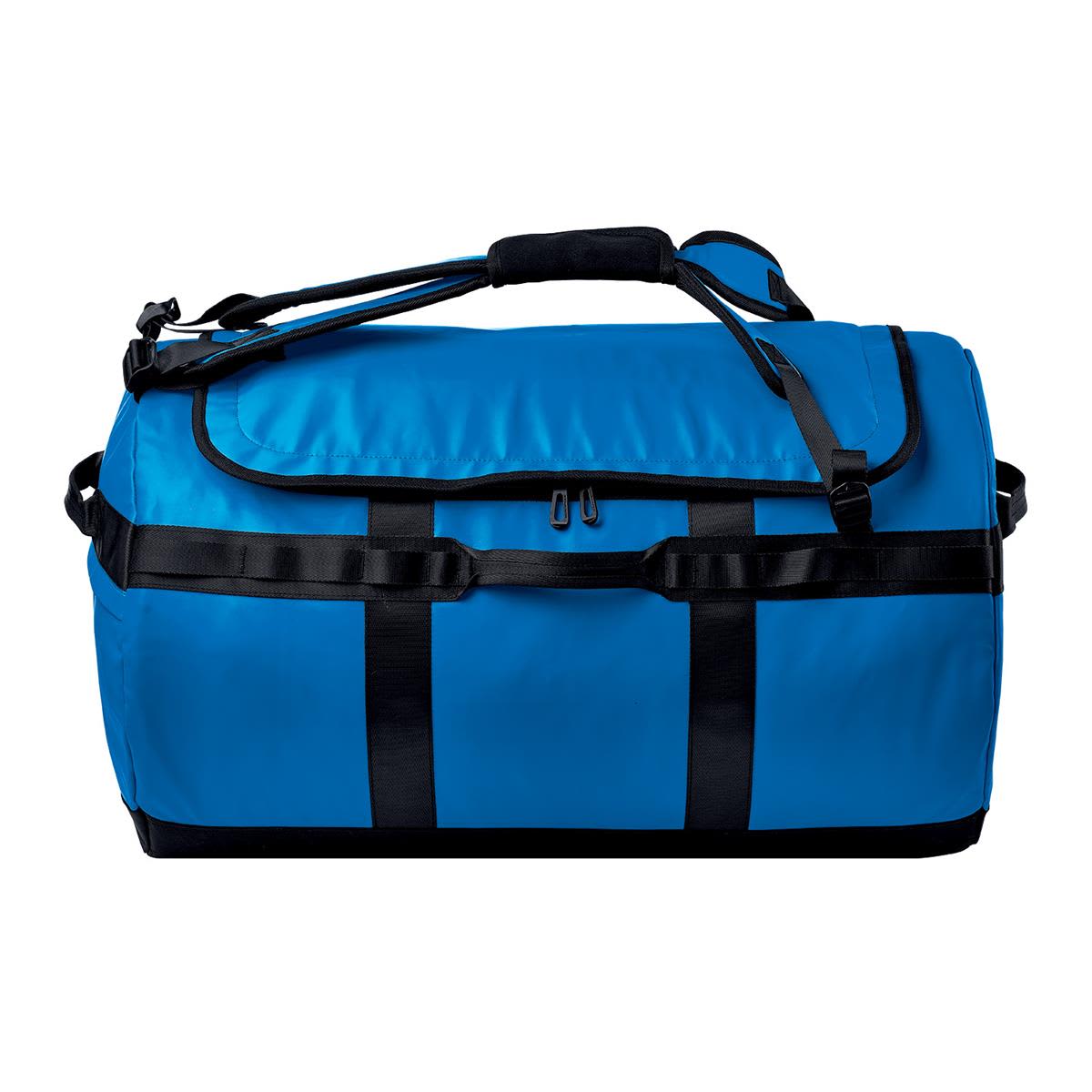 A blue duffle bag with black accents, featuring multiple straps and a zip closure. It has a logo on the side.